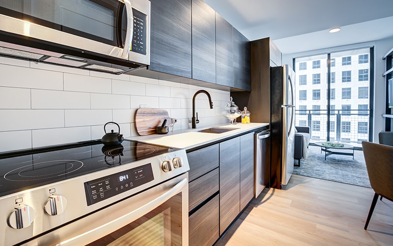 a kitchen with stainless steel appliances and wood flooring